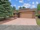 Charming home with a large garage, a well-maintained lawn, and a brick exterior that exudes curb appeal at 10506 Brown Fox Trl, Littleton, CO 80125