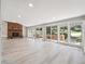 Open concept living room boasts bright windows, access to the deck, and a brick fireplace feature at 10506 Brown Fox Trl, Littleton, CO 80125