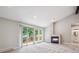 Bright living room with plush carpet and a decorative fireplace, along with large windows with access to the balcony at 10506 Brown Fox Trl, Littleton, CO 80125