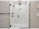 Modern shower featuring black hardware, glass enclosure, and tiled walls at 10506 Brown Fox Trl, Littleton, CO 80125