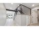 Staircase features modern railing, gray carpet steps, and wood-look floors with a lake view out the back at 10506 Brown Fox Trl, Littleton, CO 80125