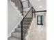 Modern staircase features gray carpet steps, contemporary metal railing, and wood-look floors at 10506 Brown Fox Trl, Littleton, CO 80125