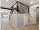Staircase boasts modern railing, gray carpet steps, and wood-look floors and a small storage area at 10506 Brown Fox Trl, Littleton, CO 80125