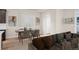 Open concept dining area with wood table and modern chairs at 21239 E 62Nd Ave, Aurora, CO 80019