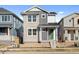 Two-story craftsman style home with light gray and stone accents at 21239 E 62Nd Ave, Aurora, CO 80019