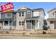 Two-story modern home with light gray and stone accents at 21239 E 62Nd Ave, Aurora, CO 80019