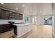 Spacious kitchen with island, dark cabinetry, and stainless steel appliances at 21239 E 62Nd Ave, Aurora, CO 80019