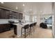 Modern kitchen with dark cabinets, island, and stainless steel appliances at 21239 E 62Nd Ave, Aurora, CO 80019