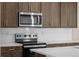 Close-up of kitchen showcasing stainless steel appliances and dark cabinetry at 21239 E 62Nd Ave, Aurora, CO 80019