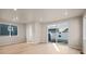 Spacious living area with light walls and hardwood floors, and sliding glass doors at 21239 E 62Nd Ave, Aurora, CO 80019