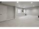 Large finished basement with neutral carpeting and recessed lighting at 12938 Bridge View Ln, Parker, CO 80134