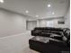 Finished basement offering recessed lights, sectional sofa and neutral walls at 12938 Bridge View Ln, Parker, CO 80134