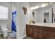 This bathroom offers white countertops, brown cabinets and a shower/tub combo at 12938 Bridge View Ln, Parker, CO 80134
