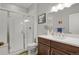 Bathroom featuring a glass-enclosed shower, wood vanity, and modern fixtures at 12938 Bridge View Ln, Parker, CO 80134