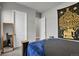 This bedroom features an ornate tapestry, closet and neutral walls at 12938 Bridge View Ln, Parker, CO 80134
