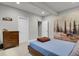 Bedroom with neutral walls, wood bed frame, and unique wall art at 12938 Bridge View Ln, Parker, CO 80134