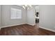 Open dining area with a modern chandelier and hardwood flooring at 12938 Bridge View Ln, Parker, CO 80134