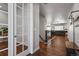Spacious hallway featuring hardwood floors and a view of the living room beyond at 12938 Bridge View Ln, Parker, CO 80134