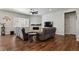 Inviting living room with dark wood floors, a fireplace, a ceiling fan, and plenty of natural light at 12938 Bridge View Ln, Parker, CO 80134