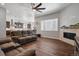 Comfortable living room with fireplace, lots of natural light, and open access to the kitchen at 12938 Bridge View Ln, Parker, CO 80134