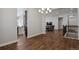 Open-concept living area with hardwood floors and view into the dining and kitchen spaces at 12938 Bridge View Ln, Parker, CO 80134