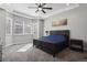 Serene main bedroom with large windows, tray ceiling, and a comfortable dark wood bed at 12938 Bridge View Ln, Parker, CO 80134