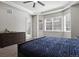 Bright main bedroom with large windows, tray ceiling, and a door to the exterior at 12938 Bridge View Ln, Parker, CO 80134