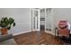 Bright home office with hardwood floors and views of hallway through glass doors at 12938 Bridge View Ln, Parker, CO 80134