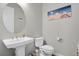 This powder room has a decorative mirror and artwork on the walls at 12938 Bridge View Ln, Parker, CO 80134