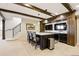 Finished basement with a custom bar, marble countertops, dark wood cabinetry and exposed wood beams at 12457 Topaz Vista Way, Castle Pines, CO 80108