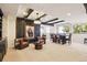 Basement featuring comfortable seating, chandelier lighting, and views to the yard at 12457 Topaz Vista Way, Castle Pines, CO 80108