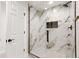 Luxurious bathroom featuring a glass enclosed shower with marble tile surround and sleek hardware at 12457 Topaz Vista Way, Castle Pines, CO 80108