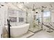 Bright bathroom features a soaking tub, glass shower and marble-like tiling at 12457 Topaz Vista Way, Castle Pines, CO 80108