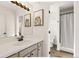 Bathroom featuring single sink vanity, framed lion artwork and shower with curtain at 12457 Topaz Vista Way, Castle Pines, CO 80108