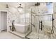 Bright bathroom features a soaking tub, glass shower and marble-like tiling at 12457 Topaz Vista Way, Castle Pines, CO 80108