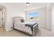 Cozy bedroom featuring a soft bed, window with bright light, and minimalist decor at 12457 Topaz Vista Way, Castle Pines, CO 80108
