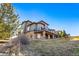 Stunning multi-level home showcasing a stone foundation and a spacious upper deck at 12457 Topaz Vista Way, Castle Pines, CO 80108