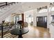 Open foyer featuring hard wood floors, front door and view of the dining room at 12457 Topaz Vista Way, Castle Pines, CO 80108