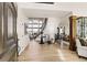 Bright foyer with wood floors, curved staircase, chandelier, and views into other living spaces at 12457 Topaz Vista Way, Castle Pines, CO 80108