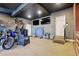 Spacious garage featuring ping pong table, motor cycle and mounted televisions at 12457 Topaz Vista Way, Castle Pines, CO 80108