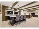 Open concept kitchen with a breakfast bar island, pendant lights, and beamed ceilings at 12457 Topaz Vista Way, Castle Pines, CO 80108