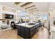 Open-concept living area with hardwood floors, a fireplace, TV, and kitchen with a central island at 12457 Topaz Vista Way, Castle Pines, CO 80108