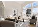 Cozy living room with large windows, high ceiling, stylish furniture, and plenty of natural light at 12457 Topaz Vista Way, Castle Pines, CO 80108