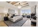 Spacious main bedroom boasts a tray ceiling, chandelier, sitting area, and fireplace at 12457 Topaz Vista Way, Castle Pines, CO 80108