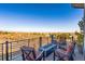 Relaxing outdoor patio featuring a fire pit with comfortable seating and beautiful mountain views at 12457 Topaz Vista Way, Castle Pines, CO 80108