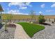 Beautiful backyard featuring an attractive artificial turf lawn, stone walkway and wooden fence at 547 Scrubjay Cir, Castle Rock, CO 80104
