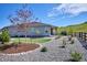 Spacious backyard with gravel landscaping, lush trees, and a view of the surrounding hillside at 547 Scrubjay Cir, Castle Rock, CO 80104