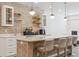 Basement bar area featuring stylish tile work, quartz countertops and pendant lighting at 547 Scrubjay Cir, Castle Rock, CO 80104