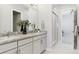 Bathroom featuring a double granite countertop vanity with sinks, framed mirrors, and glass enclosed shower at 547 Scrubjay Cir, Castle Rock, CO 80104
