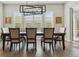 Dining room with a modern chandelier, shuttered windows, and a table with seating for six at 547 Scrubjay Cir, Castle Rock, CO 80104